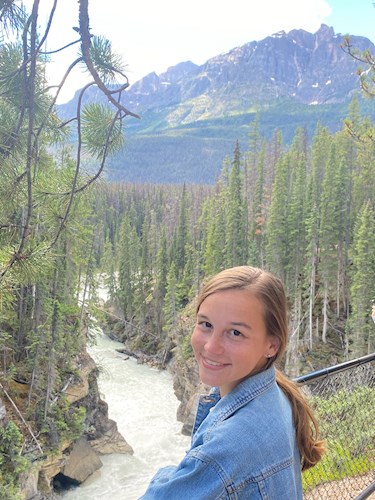 Sara stands in front of a mountain