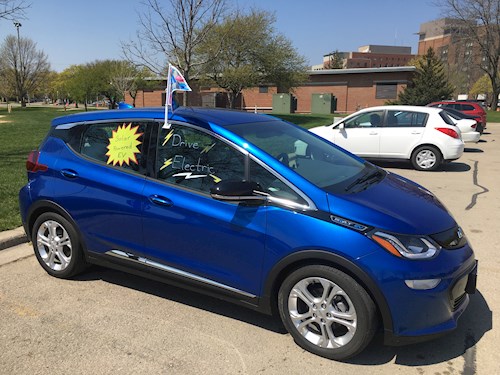 Electric vehicle with signage indicating it's powered by solar energy