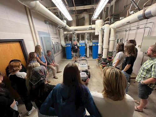Mount Horeb high school students taking a tour of their school's boiler room