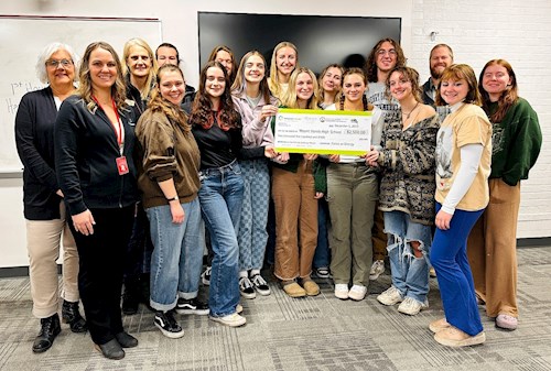 Mount Horeb AP Environmental Science Club posing with their check for winning the 2023 renew our schools challenge