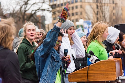 Young woman speaking at climate rally