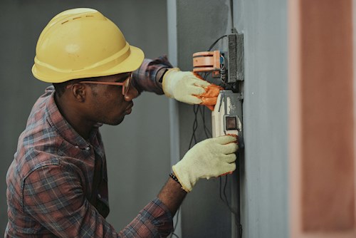 man in yellow hard hat working