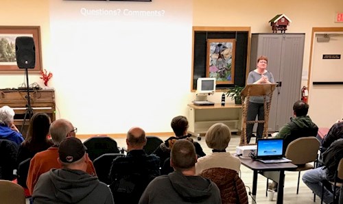 Kathy speaking in front of a crowd
