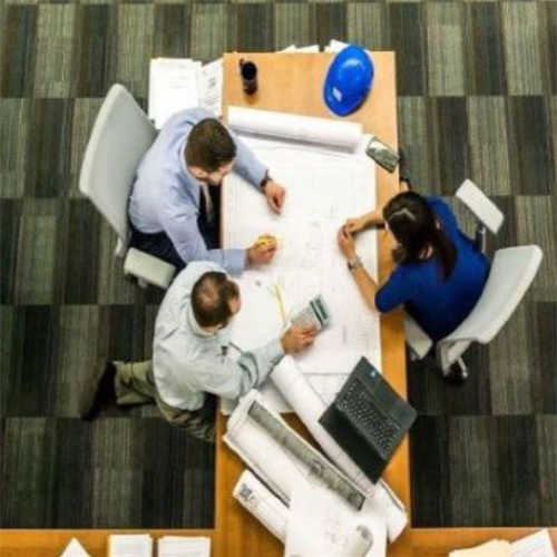 Three people meeting around a table